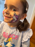 Girl with rainbow unicorn on side of face